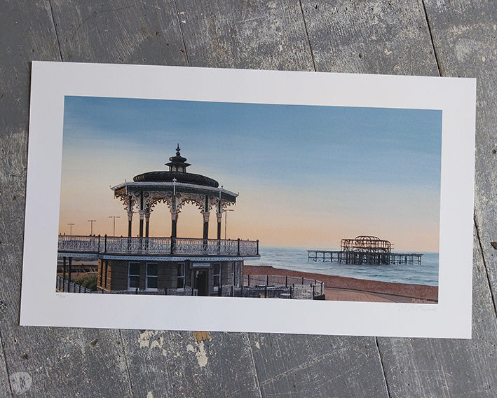 Art Print of a scenic view with Brighton bandstand and west pier on a wooden surface