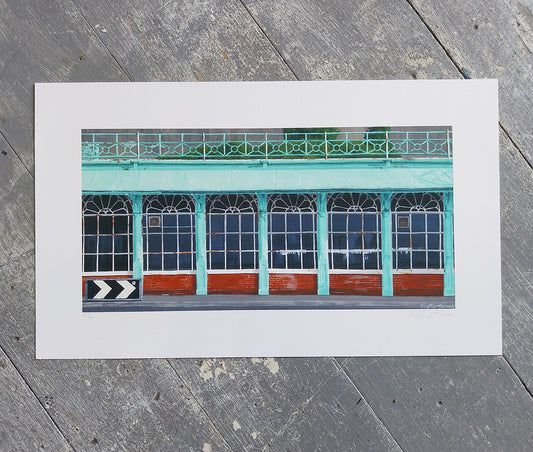 Art print of a building facade of Corncorde 2 in Brighton with green and red colors on a wooden surface