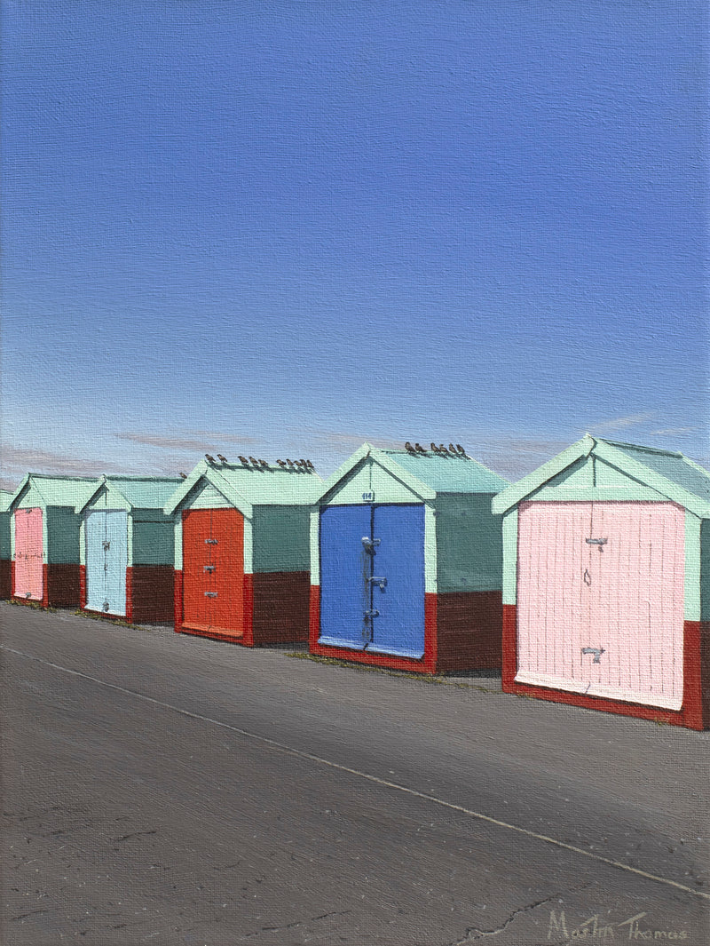 Row of colorful beach huts in Hove on a clear day with blue sky painted by Martin Thomas