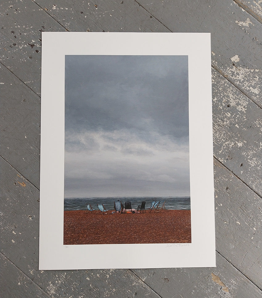 Art Print of a Brighton beach scene with deckchairs under a cloudy sky