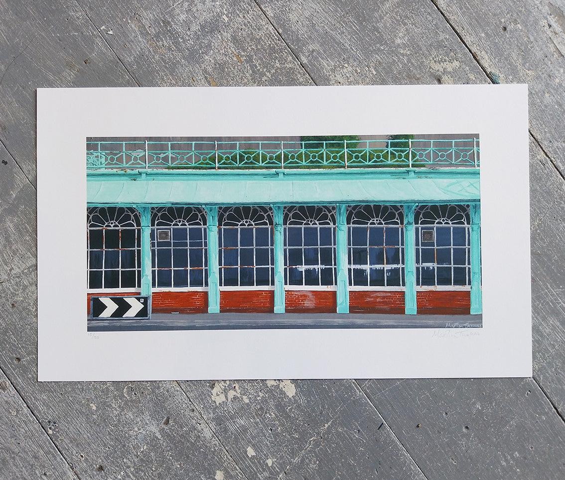 Art print of a building facade of Corncorde 2 in Brighton with green and red colors on a wooden surface