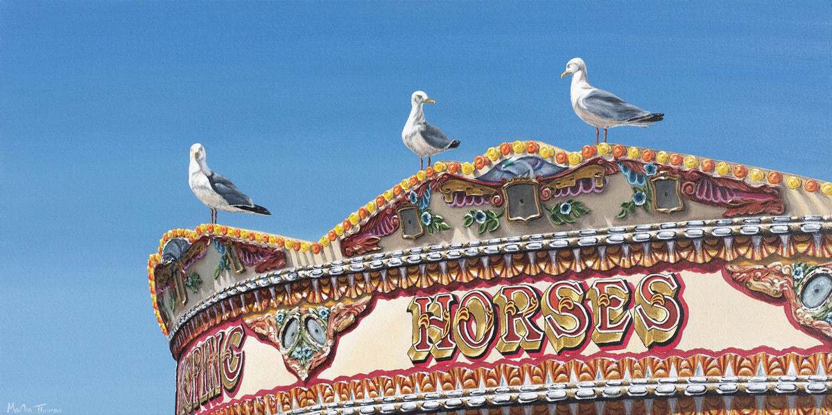 Painting by Martin Thomas of Brighton carousel roof with 'Horses' text and seagulls perched on it against a clear blue sky.