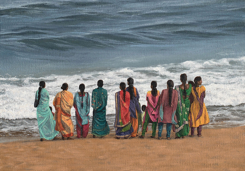 A painting by Martin Thomas of ladies in colorful saris standing on a beach in India looking at the ocean.
