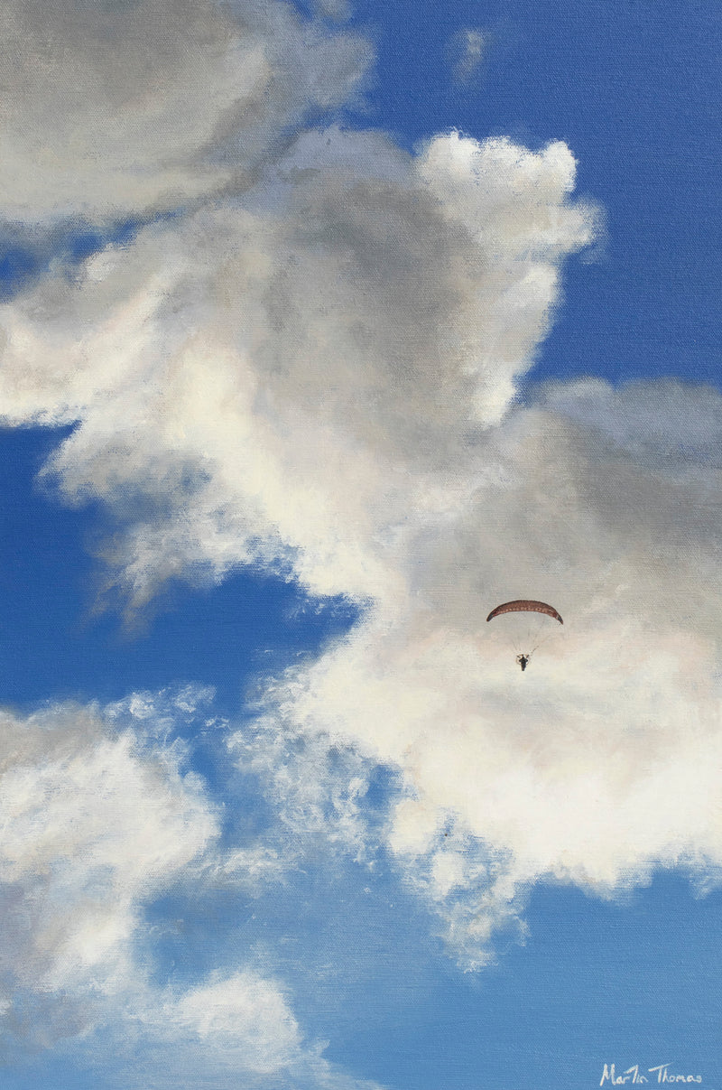 Parachute flying through a blue sky with large clouds painted by Martin Thomas
