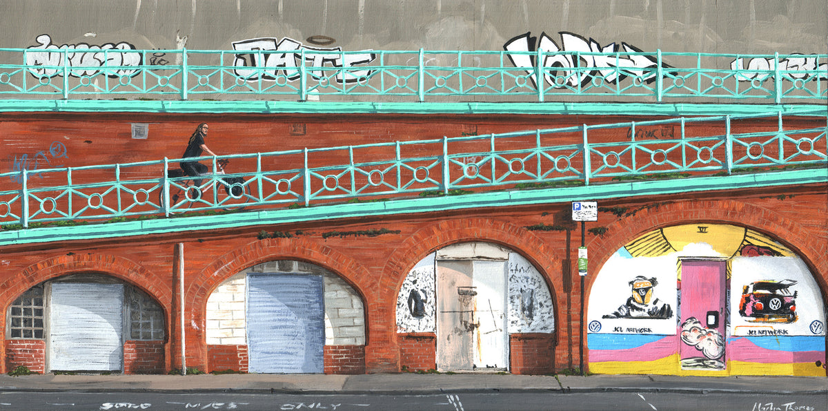 Painting by Martin Thomas of brick arches in Brighton with the iconic coloured railings and graffiti